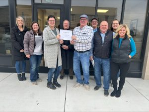 Group of people posing with a check.