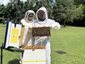 Two people with bees.