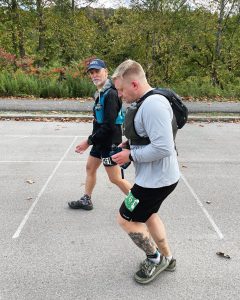 A person running with someone walking alongside him